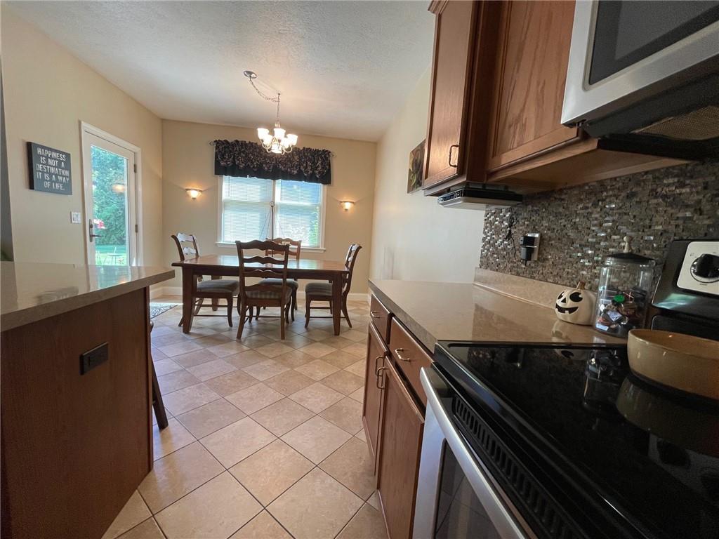 225 Wyncrest Drive Butler, PA 16001 - Photo 3 of 28 a kitchen with a sink dining table and chairs