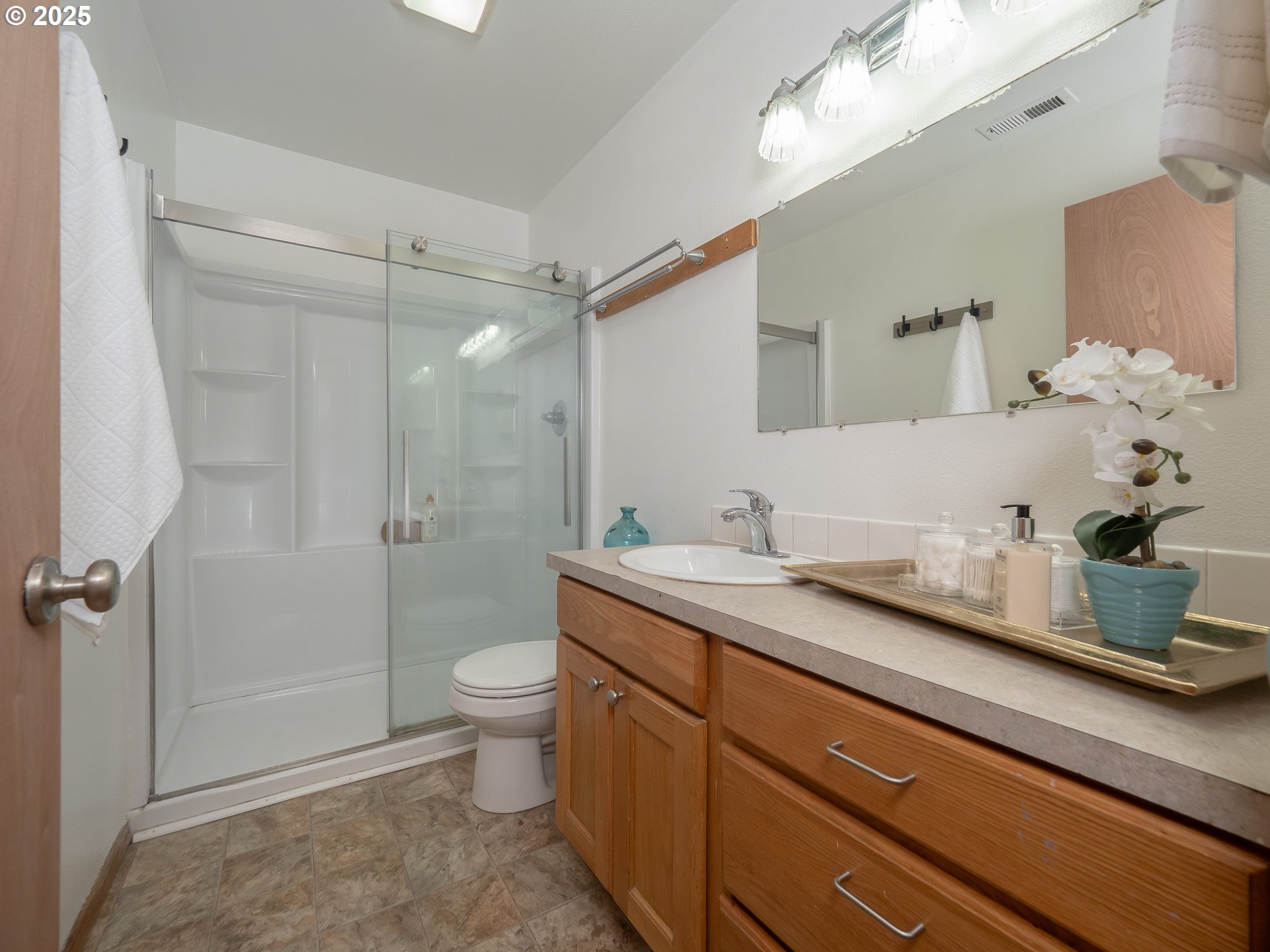 402 East Washington Street Carlton, OR 97111 - Photo 24 of 36 a bathroom with a granite countertop sink a toilet and shower