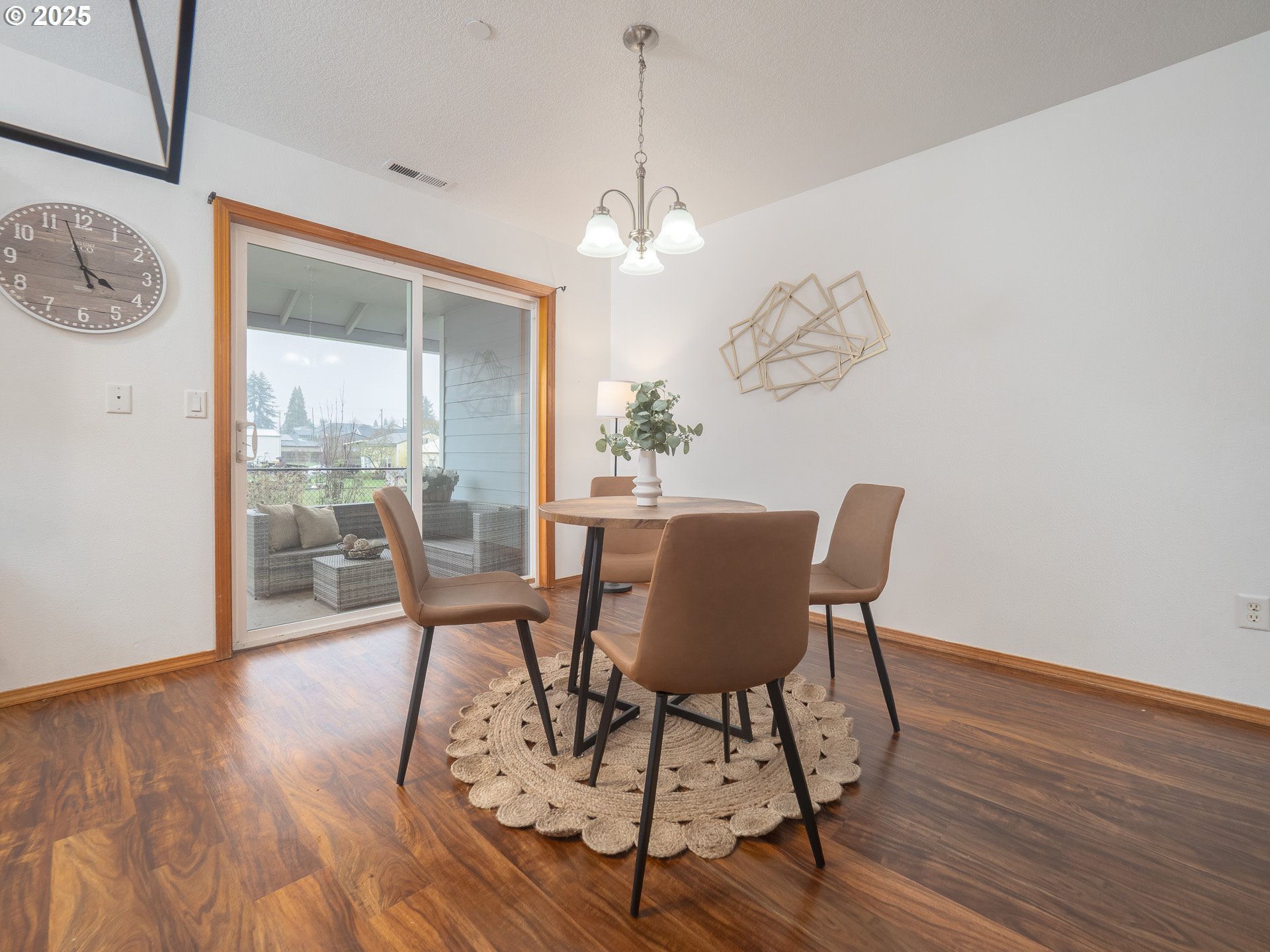 402 East Washington Street Carlton, OR 97111 - Photo 9 of 36 a dining room with furniture a chandelier and wooden floor
