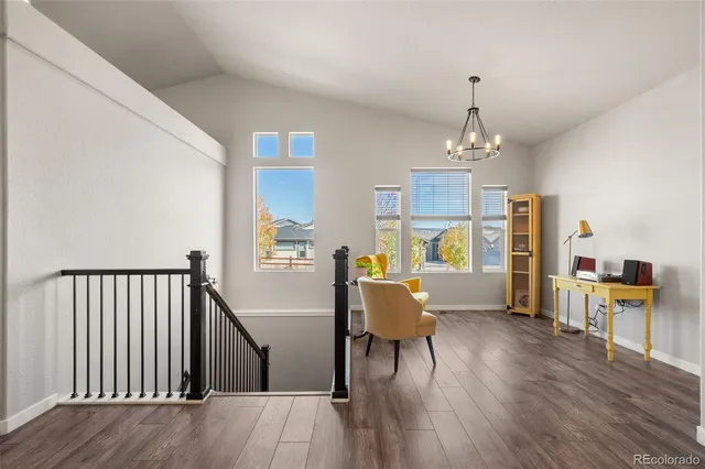 a view of a dining room with furniture wooden floor and chandelier