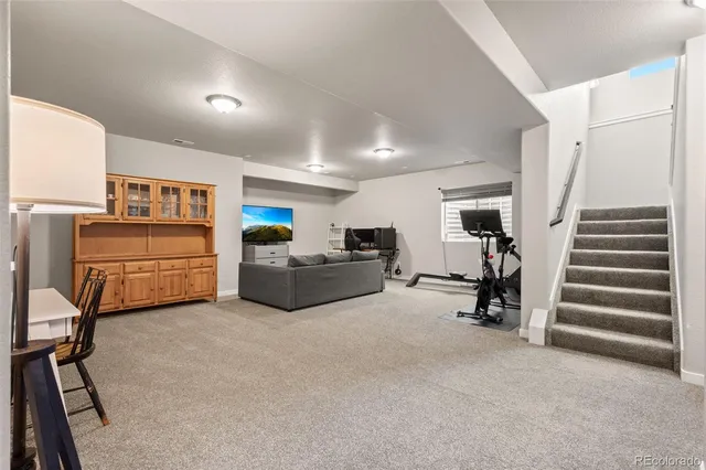 a view of a livingroom with furniture and stairs