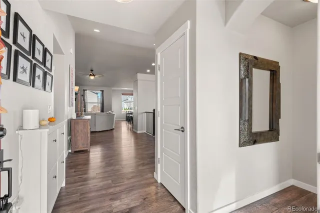 a view of a living room with furniture and wooden floor