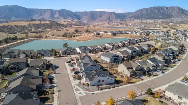an aerial view of residential house with outdoor space and mountain view