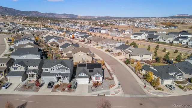 an aerial view of a residential building and parking space