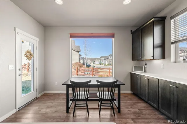 a view of a kitchen with a table and chairs
