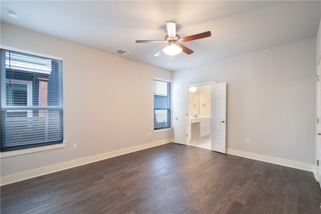 9124 Cattle Baron Path Austin, TX 78747 - Photo 12 of 36 a view of an empty room with wooden floor and a window