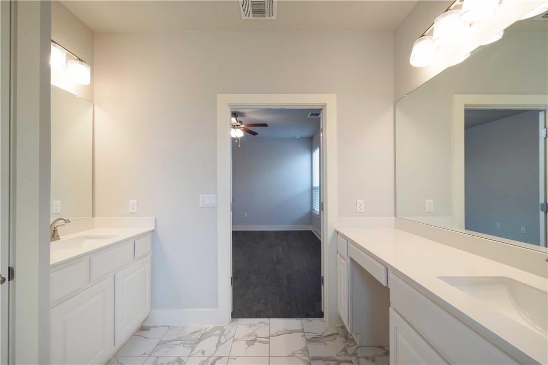 9124 Cattle Baron Path Austin, TX 78747 - Photo 16 of 36 a bathroom with a sink and a mirror