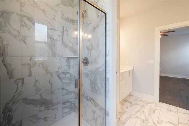 a bathroom with a glass shower door