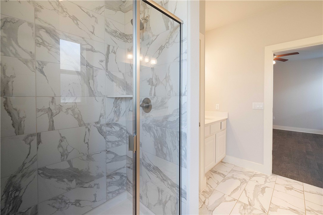 9124 Cattle Baron Path Austin, TX 78747 - Photo 17 of 36 a bathroom with a glass shower door