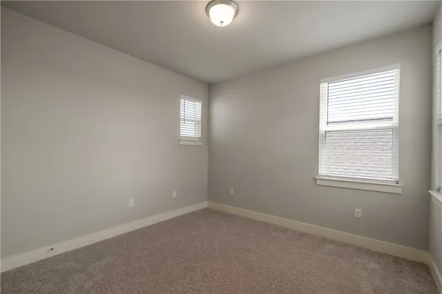 an empty room with a window and a mirror