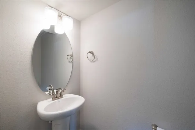 a bathroom with a sink and mirror