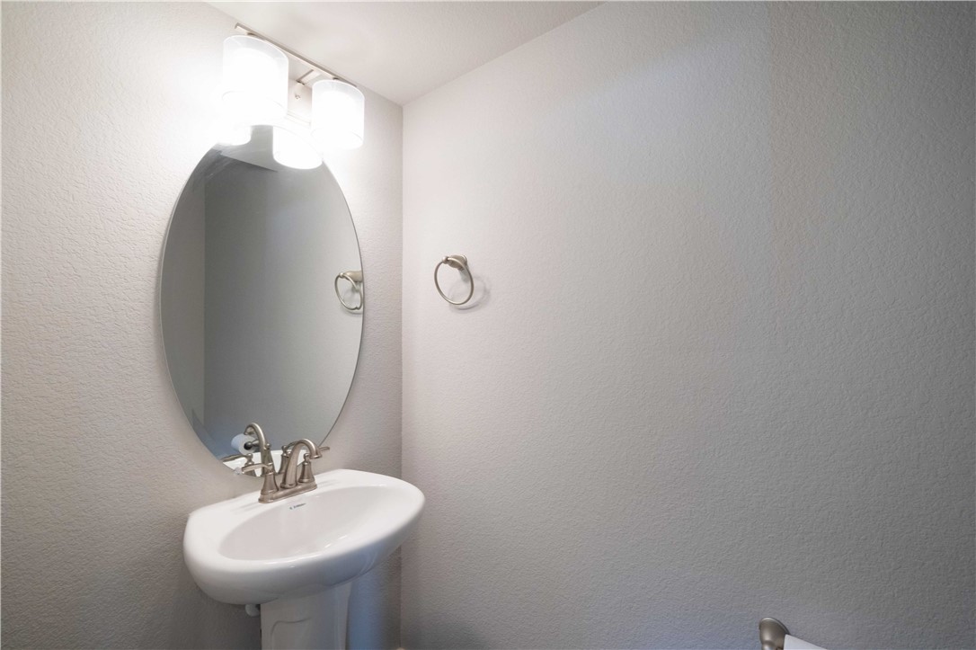 9124 Cattle Baron Path Austin, TX 78747 - Photo 26 of 36 a bathroom with a sink and mirror