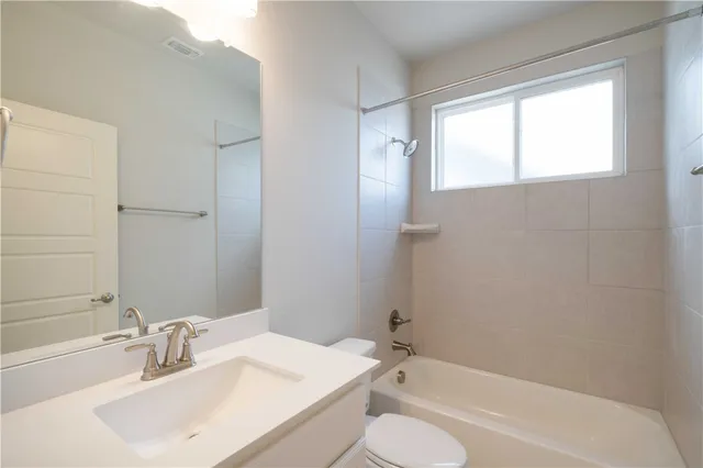 a bathroom with a sink toilet tub and shower