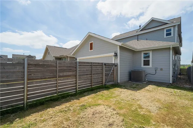 a view of a house with wooden fence