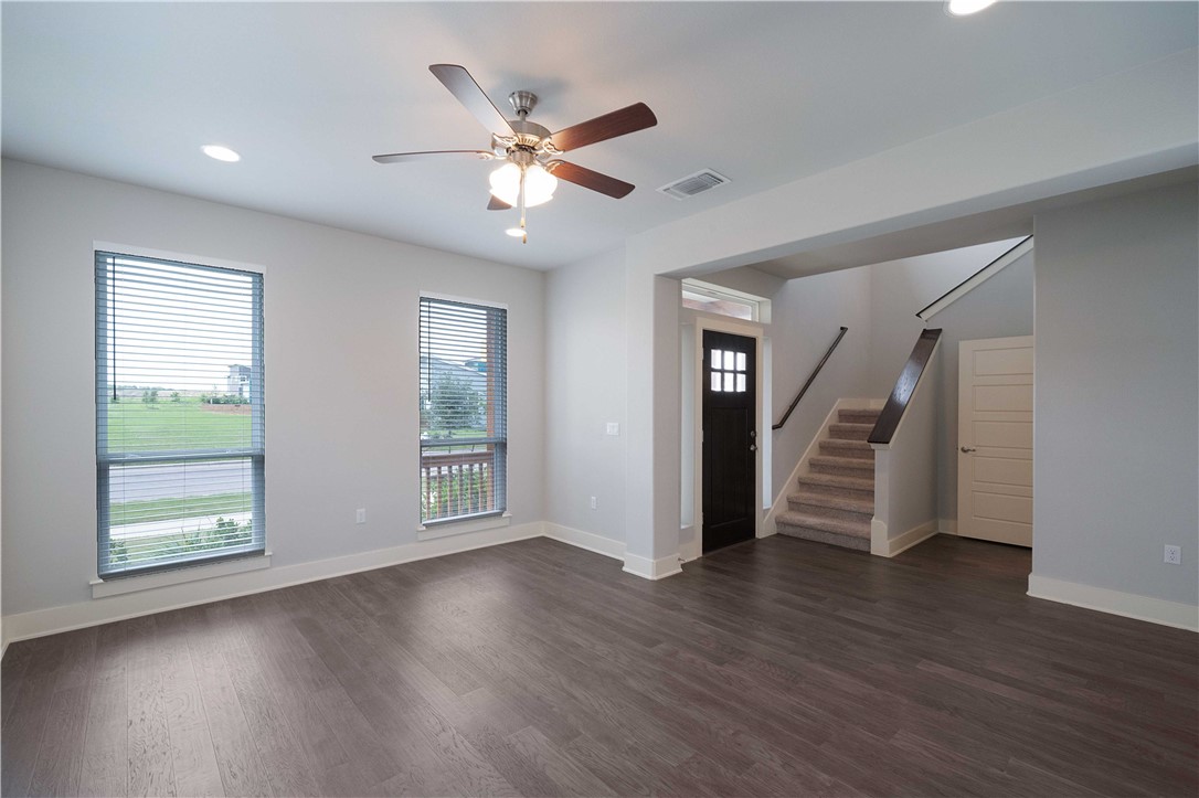 9124 Cattle Baron Path Austin, TX 78747 - Photo 4 of 36 a view of an empty room with wooden floor and a window