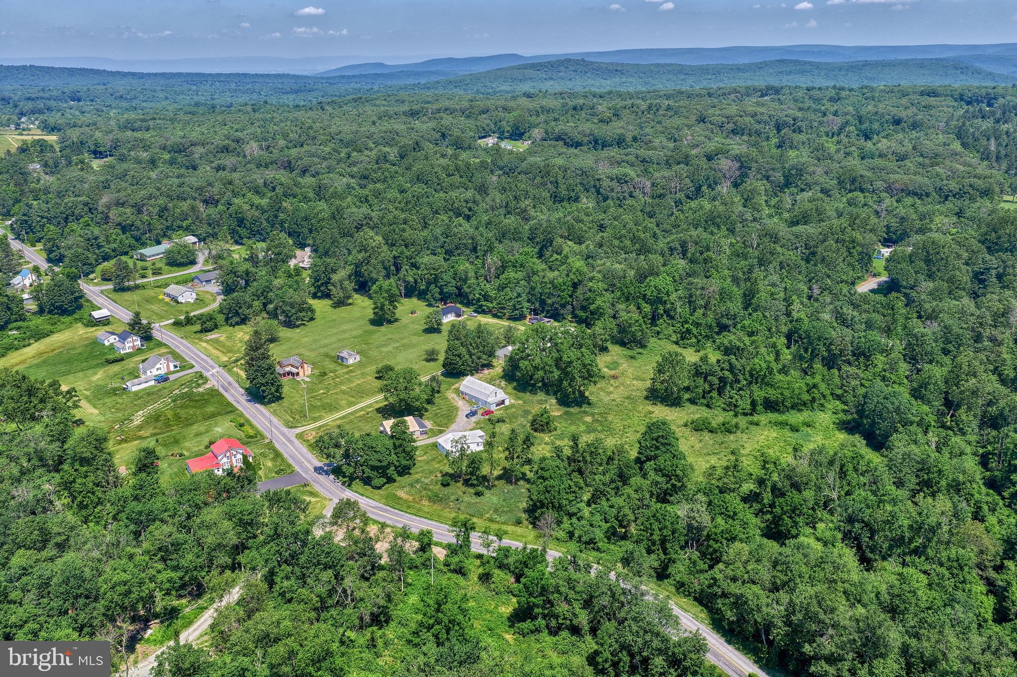 4531 Cold Springs Road Fayetteville, PA 17222 - Photo 72 of 86 a view of a lush green forest with a house and a yard