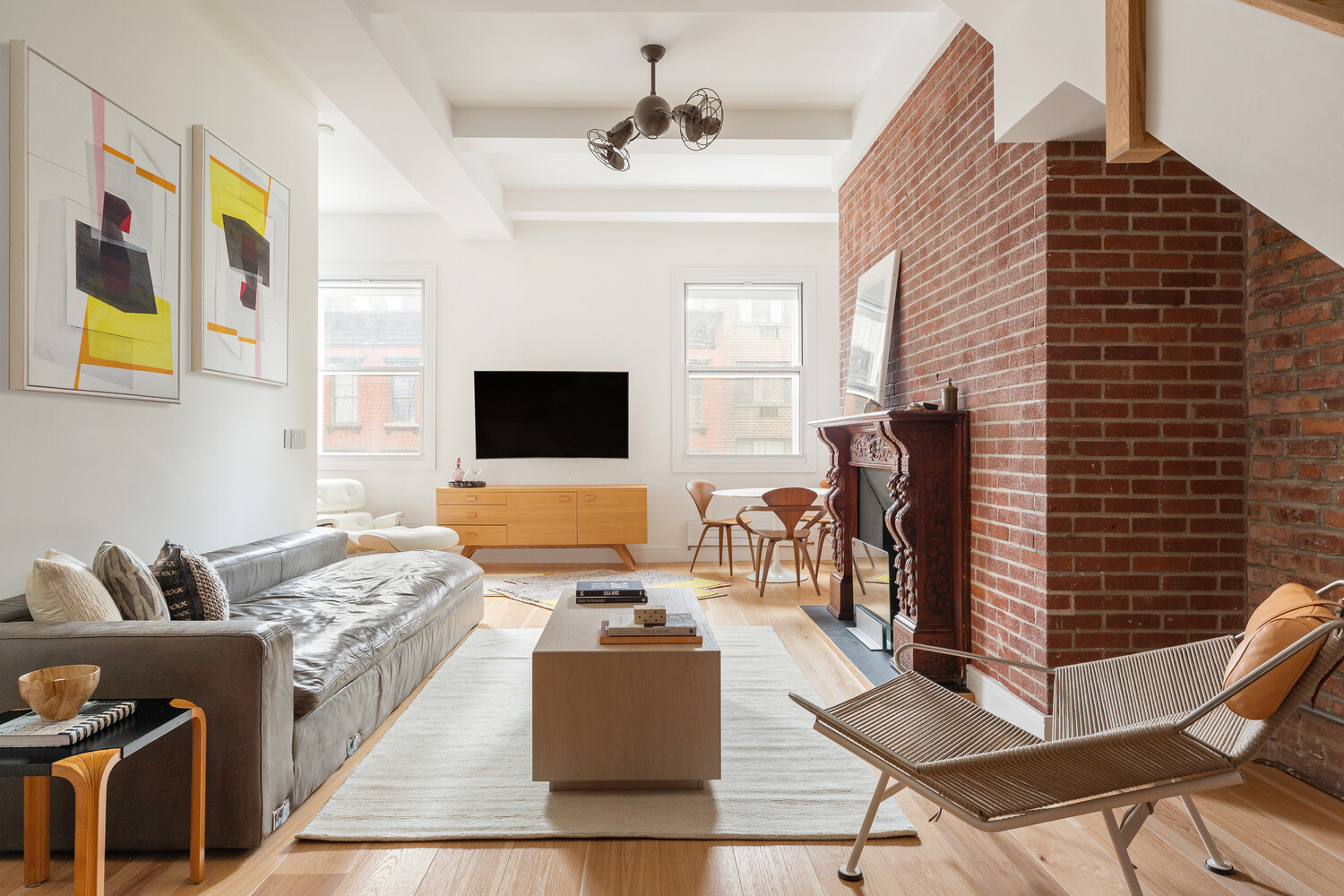 521 West 47th Street, Unit PHD Manhattan, NY 10036 - Photo 1 of 14 a living room with furniture and a flat screen tv