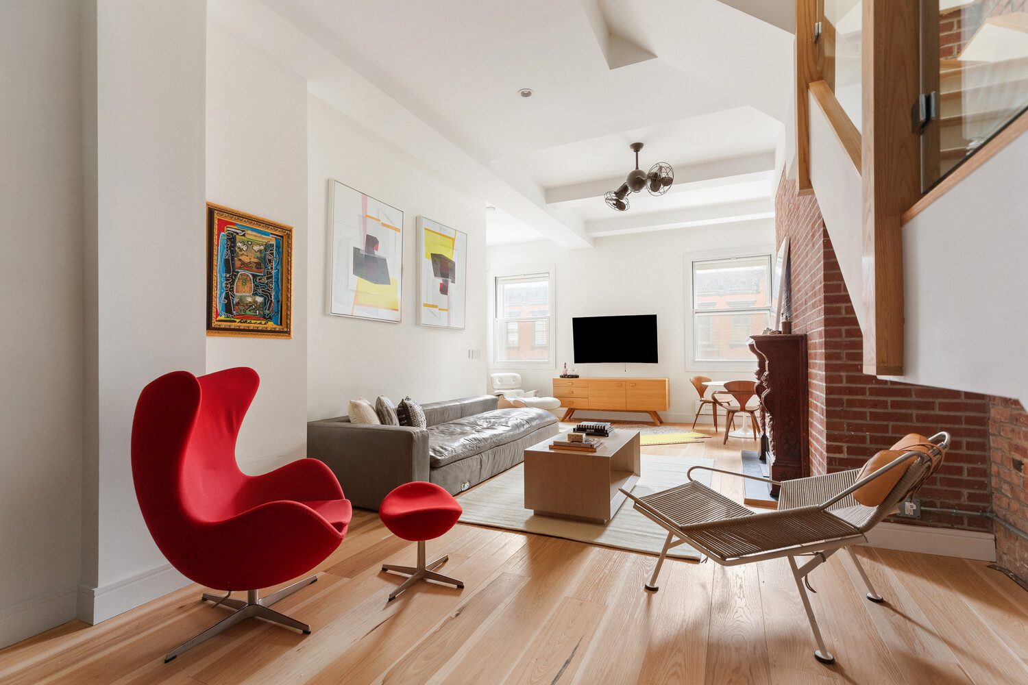 521 West 47th Street, Unit PHD Manhattan, NY 10036 - Photo 2 of 14 a living room with furniture and wooden floor