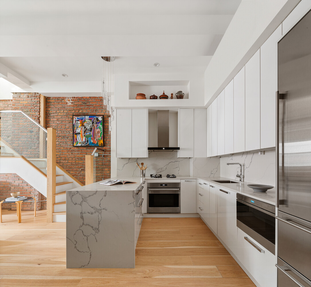 521 West 47th Street, Unit PHD Manhattan, NY 10036 - Photo 4 of 14 a kitchen with stainless steel appliances granite countertop a stove top oven a sink and a refrigerator