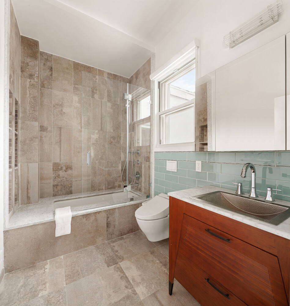 521 West 47th Street, Unit PHD Manhattan, NY 10036 - Photo 7 of 14 a bathroom with a sink a toilet and bathtub