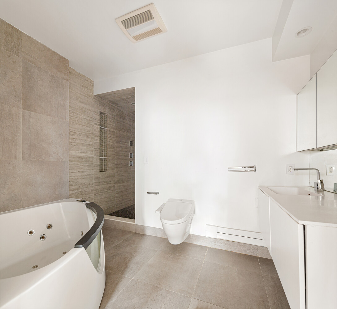 521 West 47th Street, Unit PHD Manhattan, NY 10036 - Photo 9 of 14 a bathroom with a tub sink and toilet