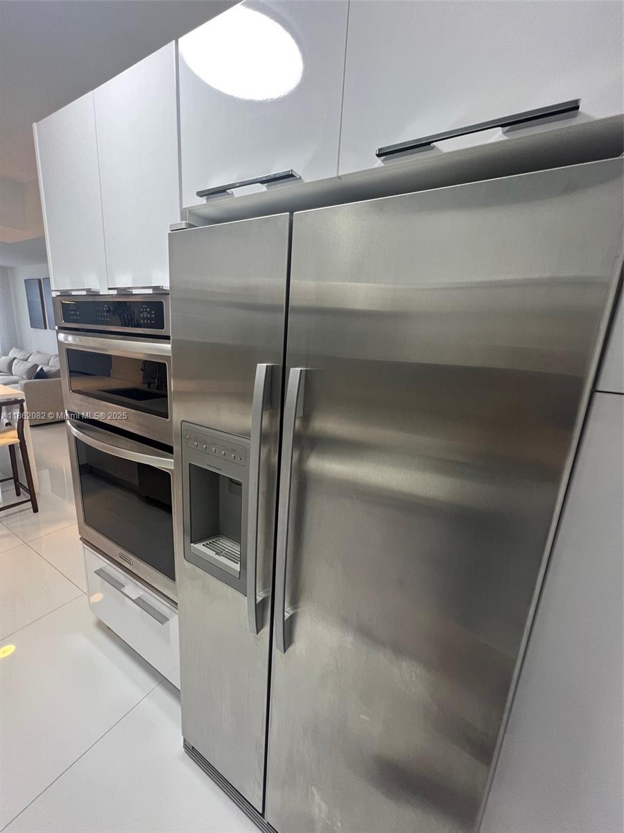 100 Lincoln Road, Unit 1022 Miami Beach, FL 33139 - Photo 13 of 63 a kitchen with appliances and cabinets