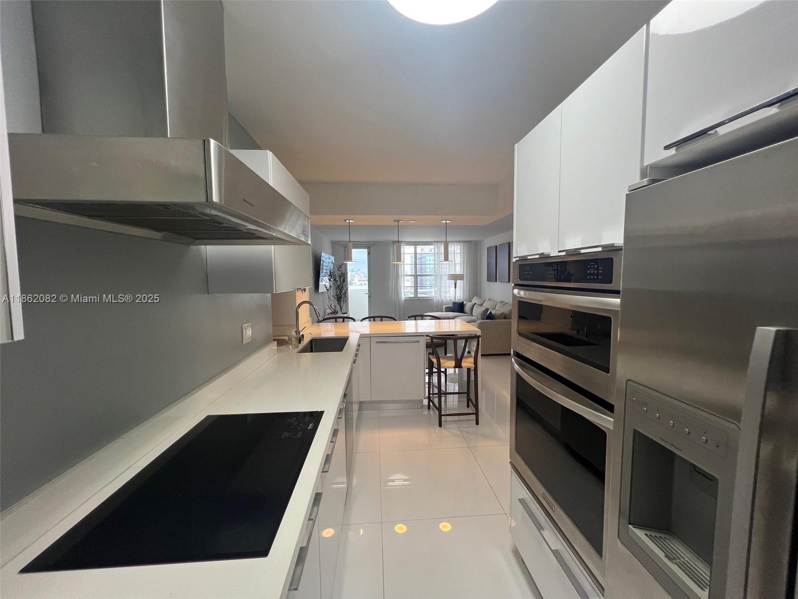 100 Lincoln Road, Unit 1022 Miami Beach, FL 33139 - Photo 14 of 63 a kitchen with a sink appliances and cabinets