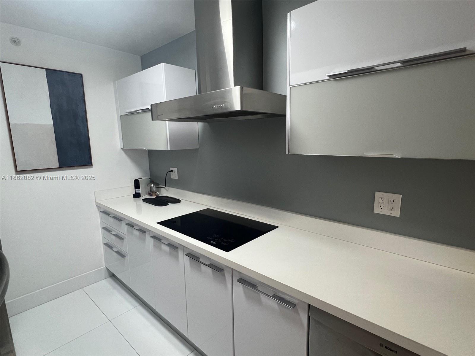 100 Lincoln Road, Unit 1022 Miami Beach, FL 33139 - Photo 15 of 63 a kitchen with a stove and a refrigerator