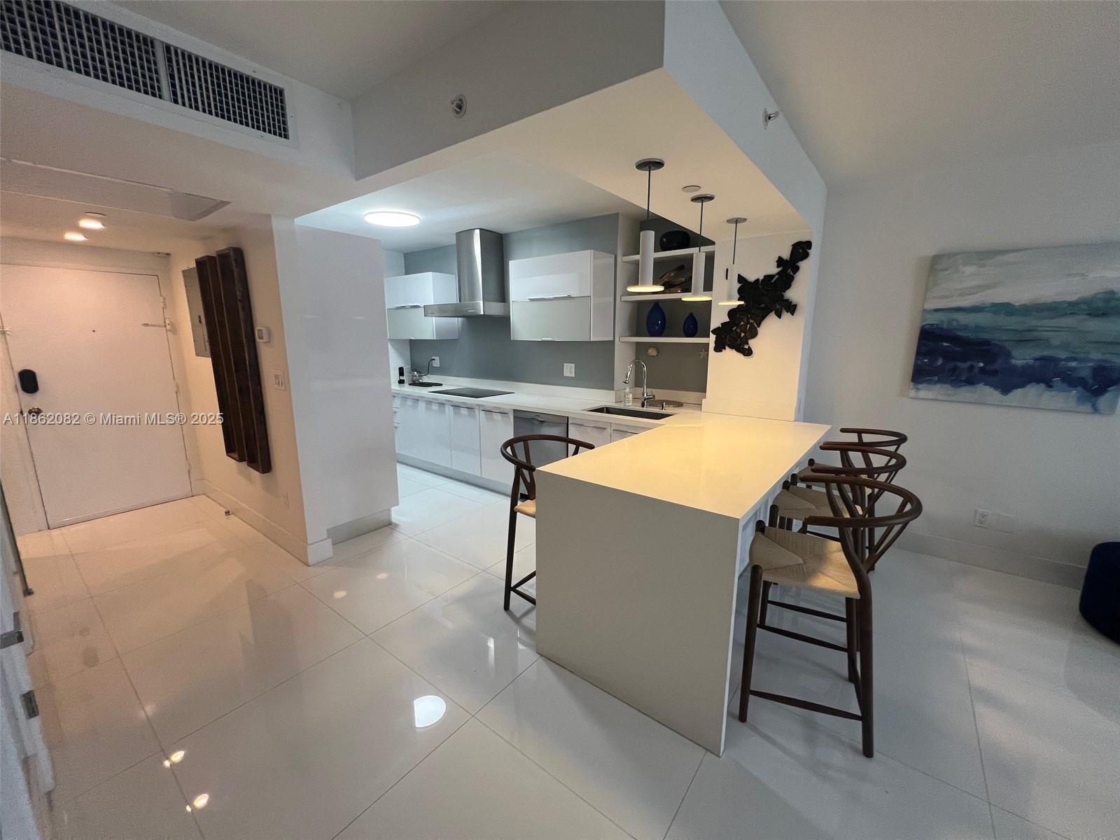 100 Lincoln Road, Unit 1022 Miami Beach, FL 33139 - Photo 20 of 63 a kitchen with stainless steel appliances granite countertop a sink a stove and a refrigerator
