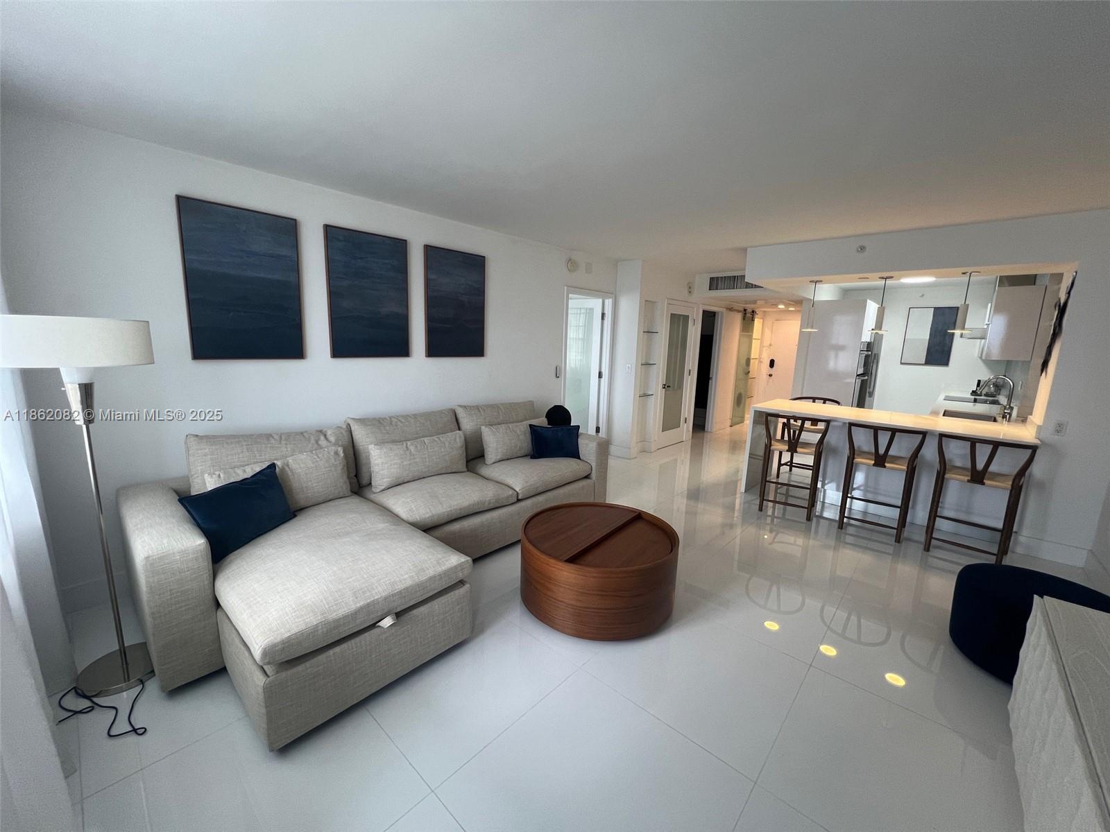 100 Lincoln Road, Unit 1022 Miami Beach, FL 33139 - Photo 2 of 63 a living room with furniture and a table