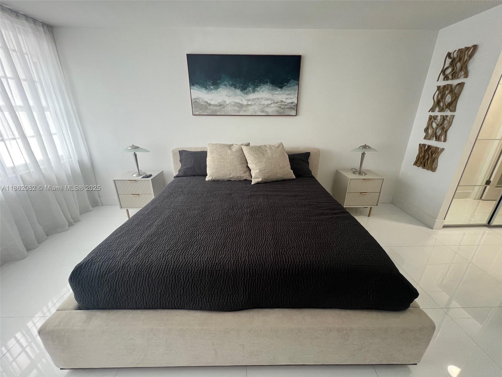 100 Lincoln Road, Unit 1022 Miami Beach, FL 33139 - Photo 23 of 63 a bedroom with a bed and a painting on the wall