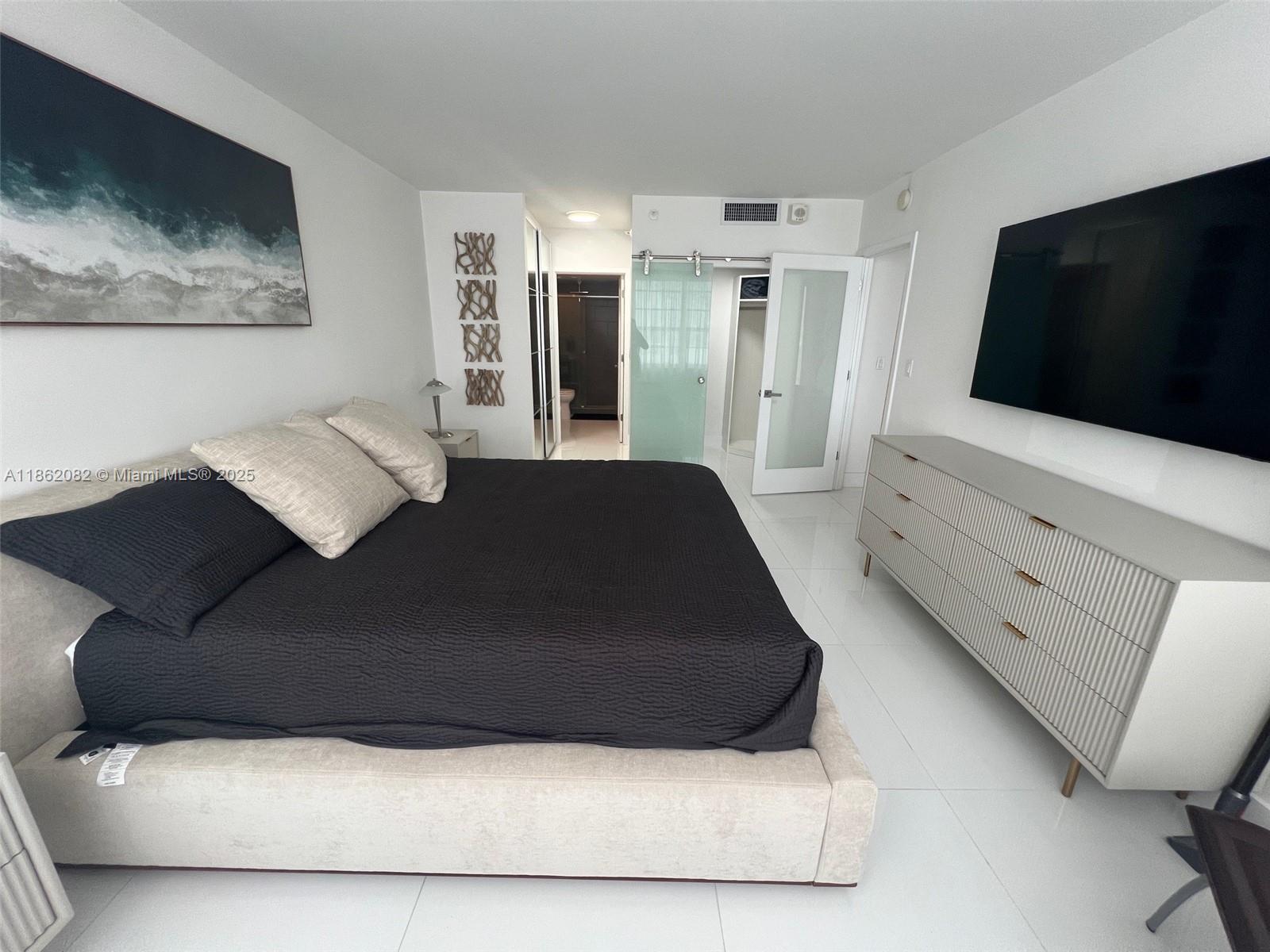 100 Lincoln Road, Unit 1022 Miami Beach, FL 33139 - Photo 25 of 63 a living room with furniture and a flat screen tv