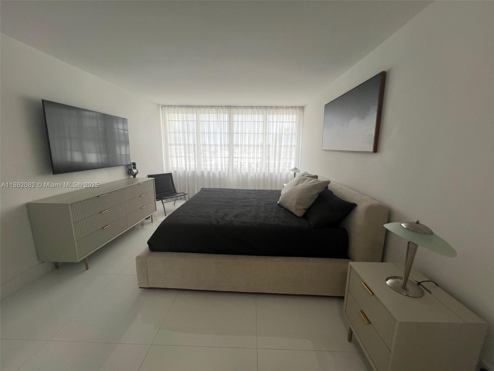 100 Lincoln Road, Unit 1022 Miami Beach, FL 33139 - Photo 26 of 63 a bedroom with a bed and window