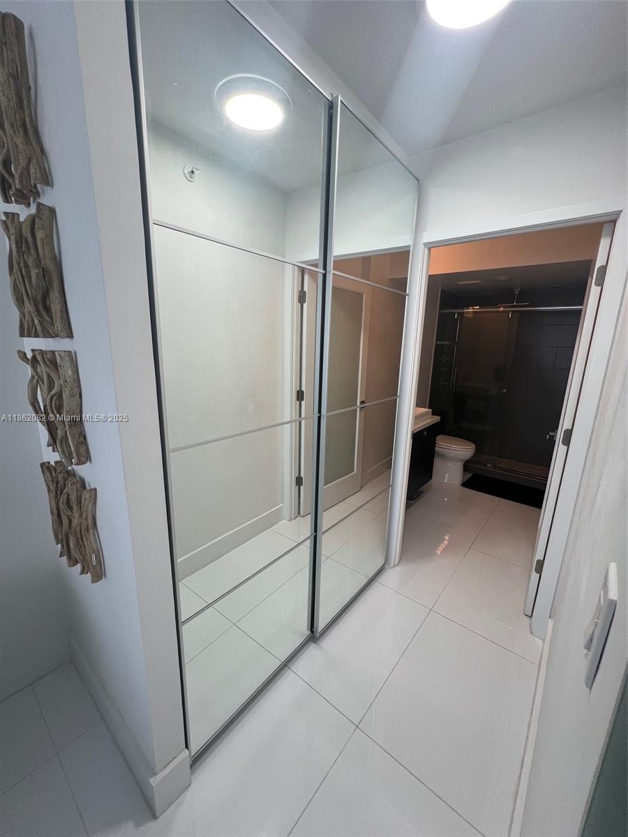 100 Lincoln Road, Unit 1022 Miami Beach, FL 33139 - Photo 31 of 63 a bathroom with a shower and a mirror