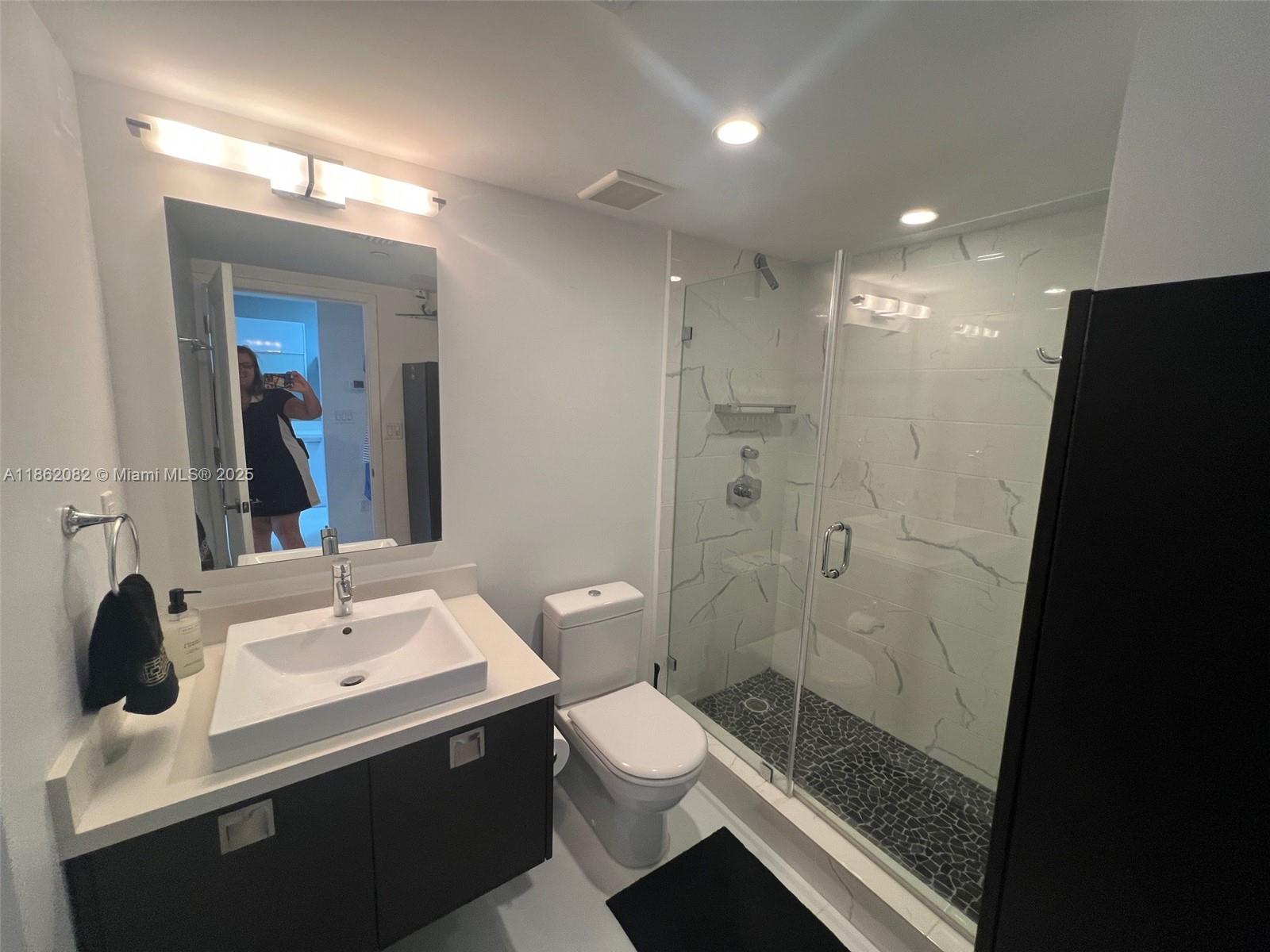 100 Lincoln Road, Unit 1022 Miami Beach, FL 33139 - Photo 37 of 63 a bathroom with a sink a toilet and shower