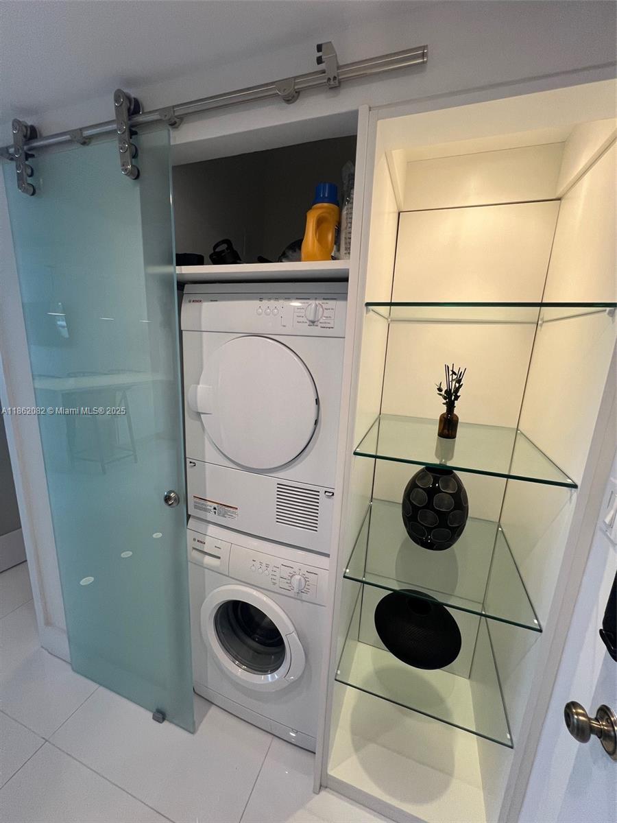 100 Lincoln Road, Unit 1022 Miami Beach, FL 33139 - Photo 38 of 63 a utility room with dryer and washer
