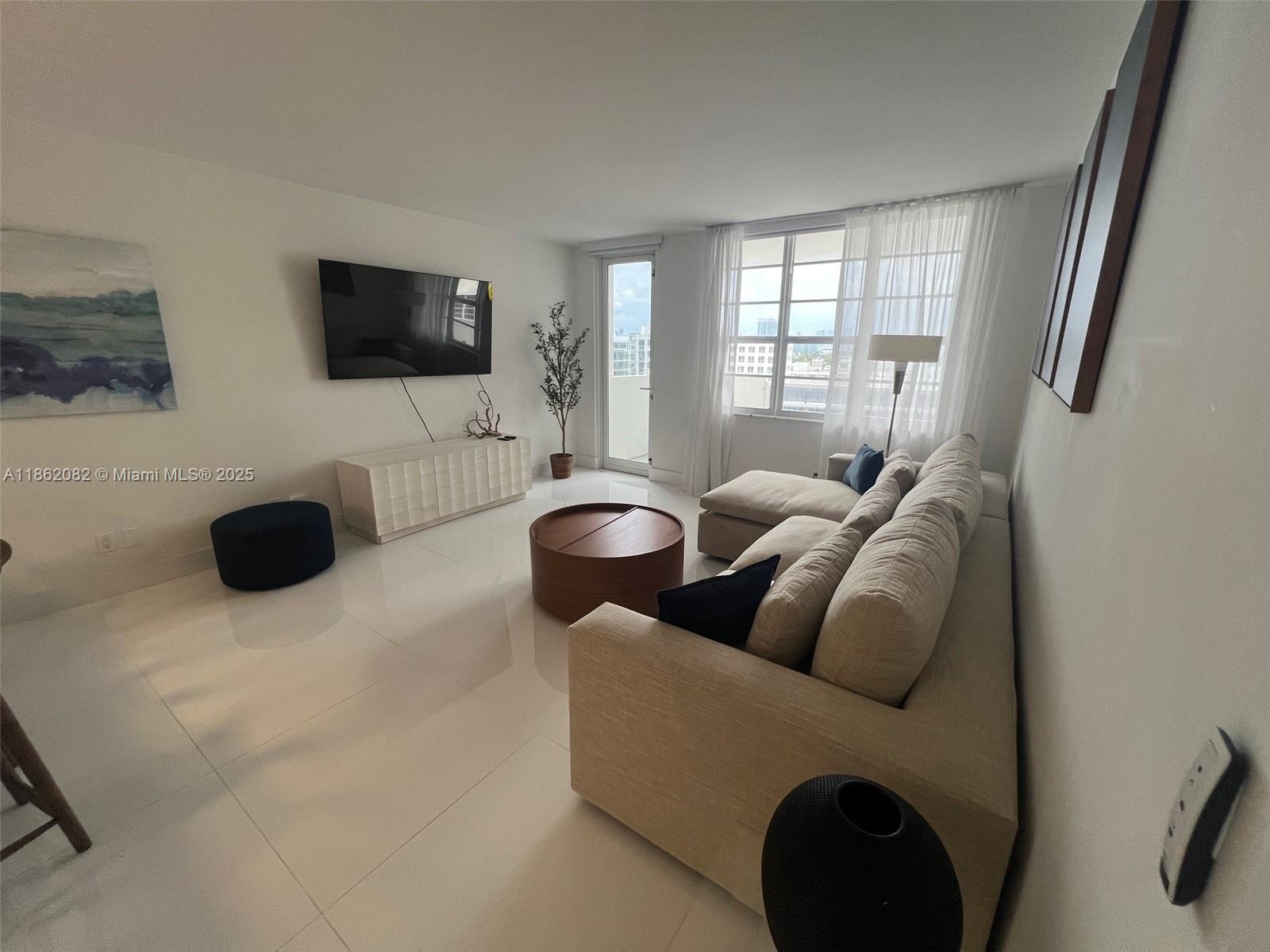 100 Lincoln Road, Unit 1022 Miami Beach, FL 33139 - Photo 4 of 63 a living room with furniture and a flat screen tv