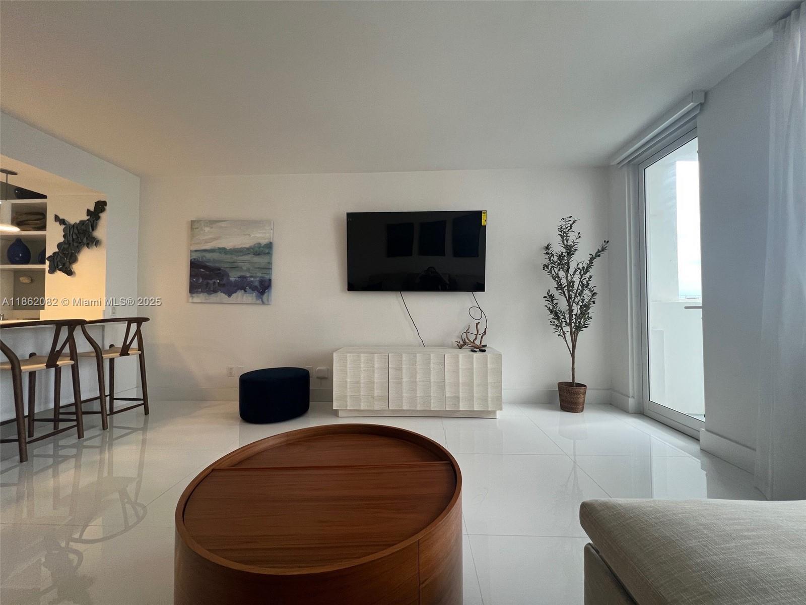 100 Lincoln Road, Unit 1022 Miami Beach, FL 33139 - Photo 6 of 63 a living room with furniture and a flat screen tv