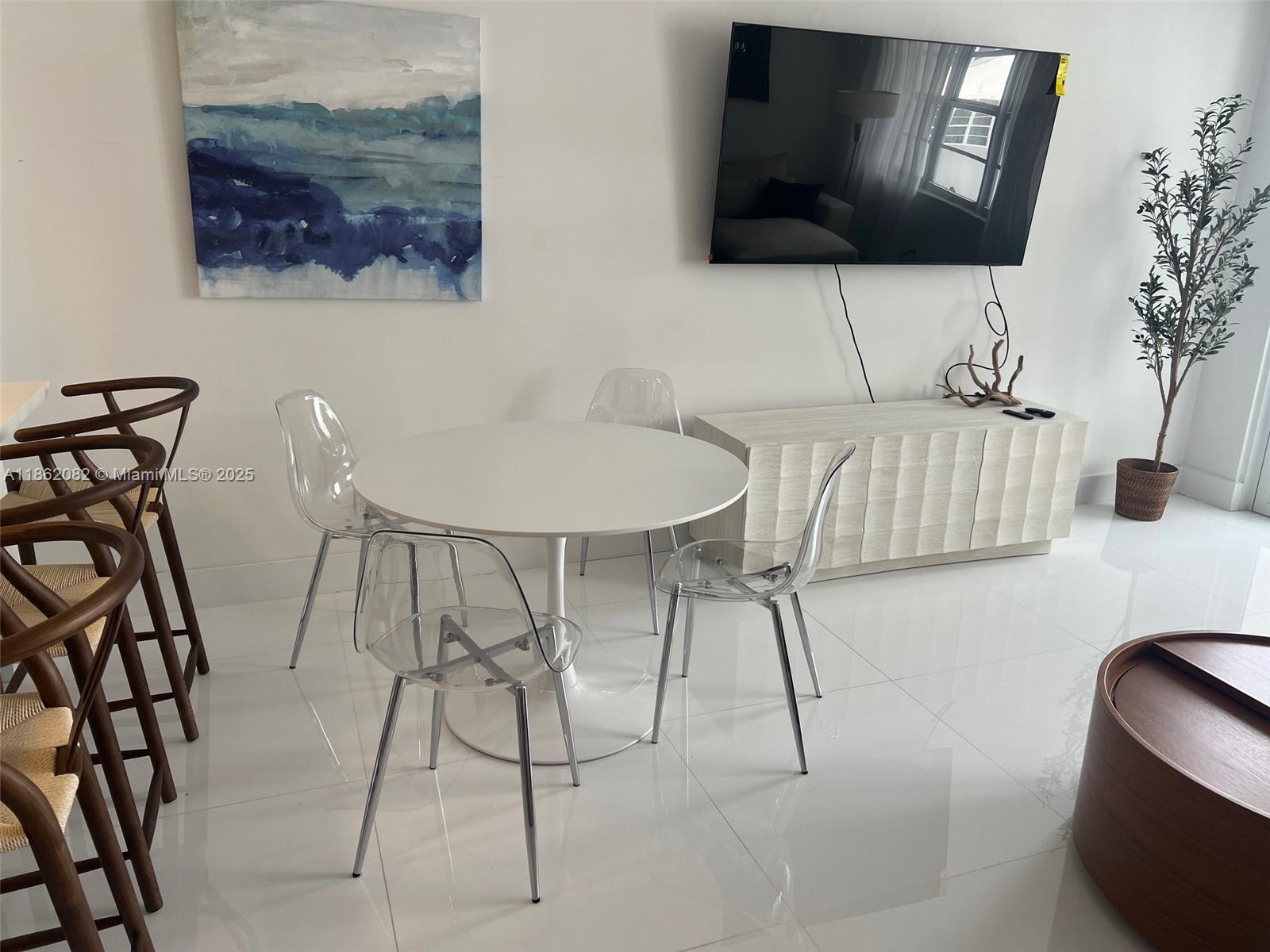 100 Lincoln Road, Unit 1022 Miami Beach, FL 33139 - Photo 8 of 63 a living room with furniture and a flat screen tv