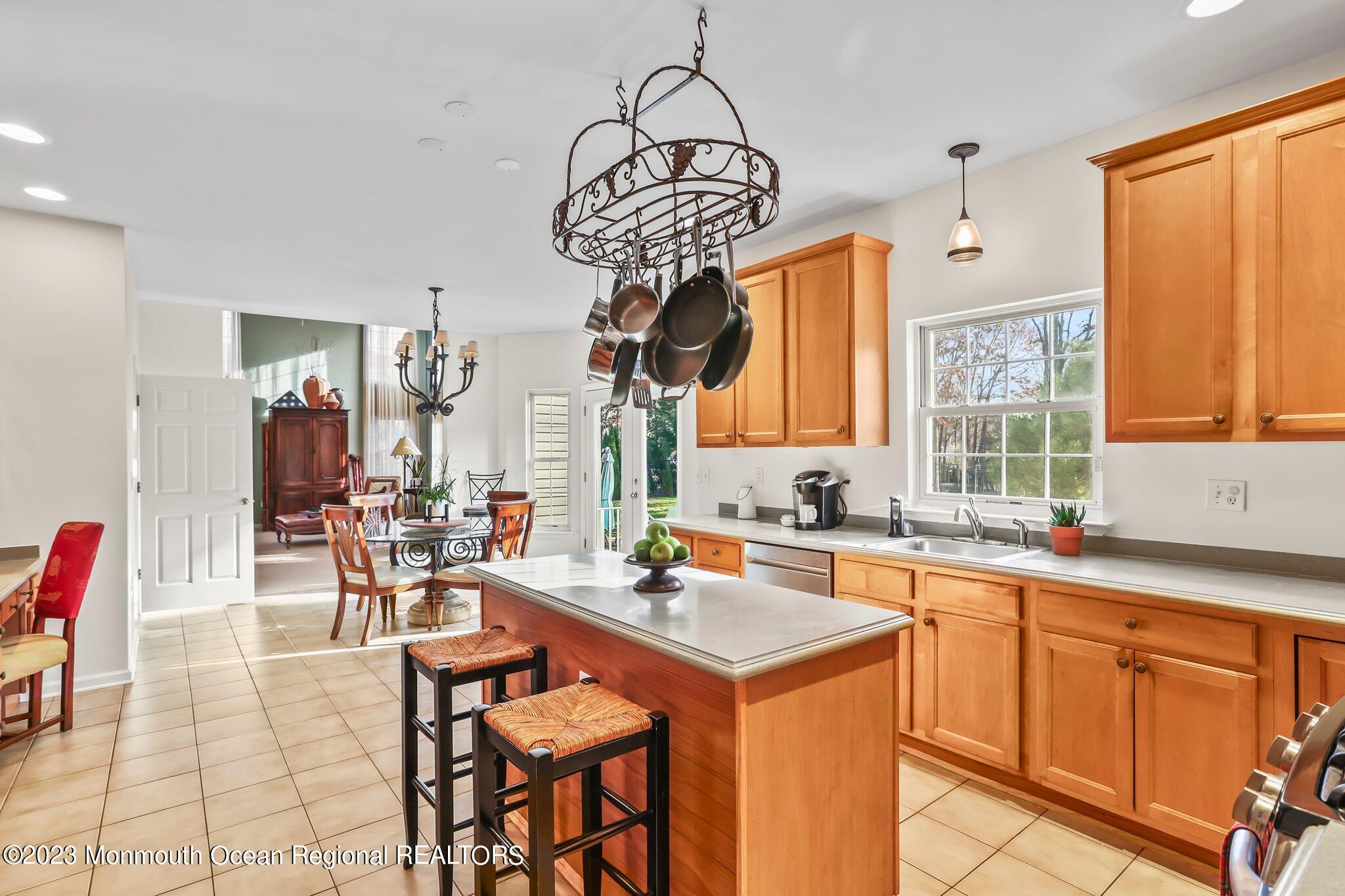 20 Round Hill Road Jackson, NJ 08527 - Photo 11 of 50 a very nice looking kitchen with granite countertop a stove a sink a dining table and chairs