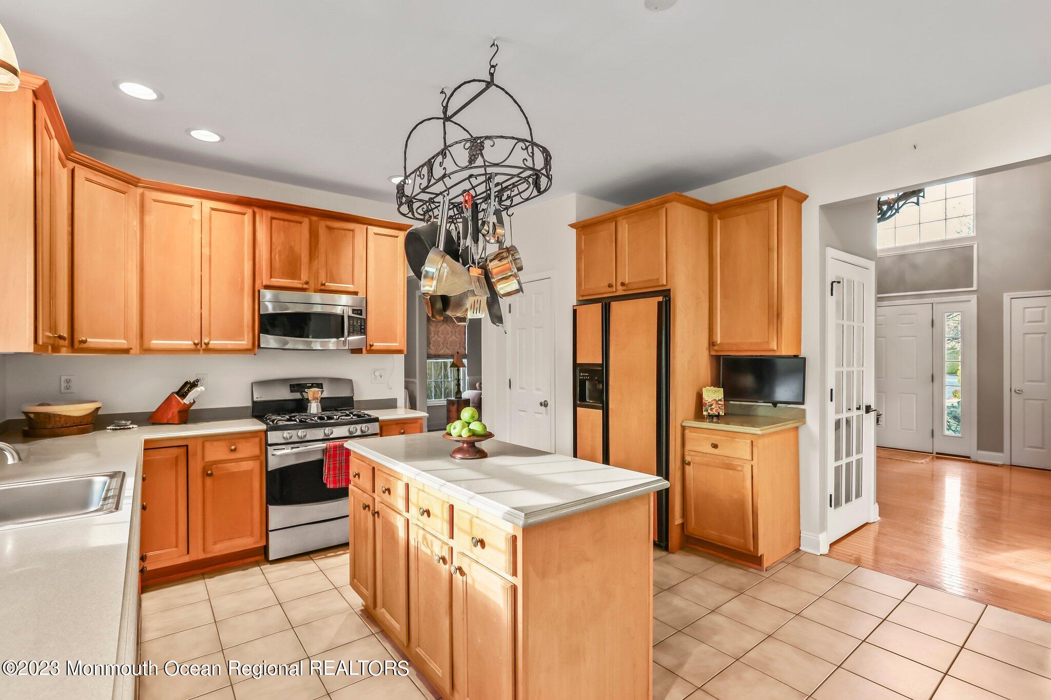 20 Round Hill Road Jackson, NJ 08527 - Photo 14 of 50 a kitchen with stainless steel appliances a stove refrigerator sink and microwave