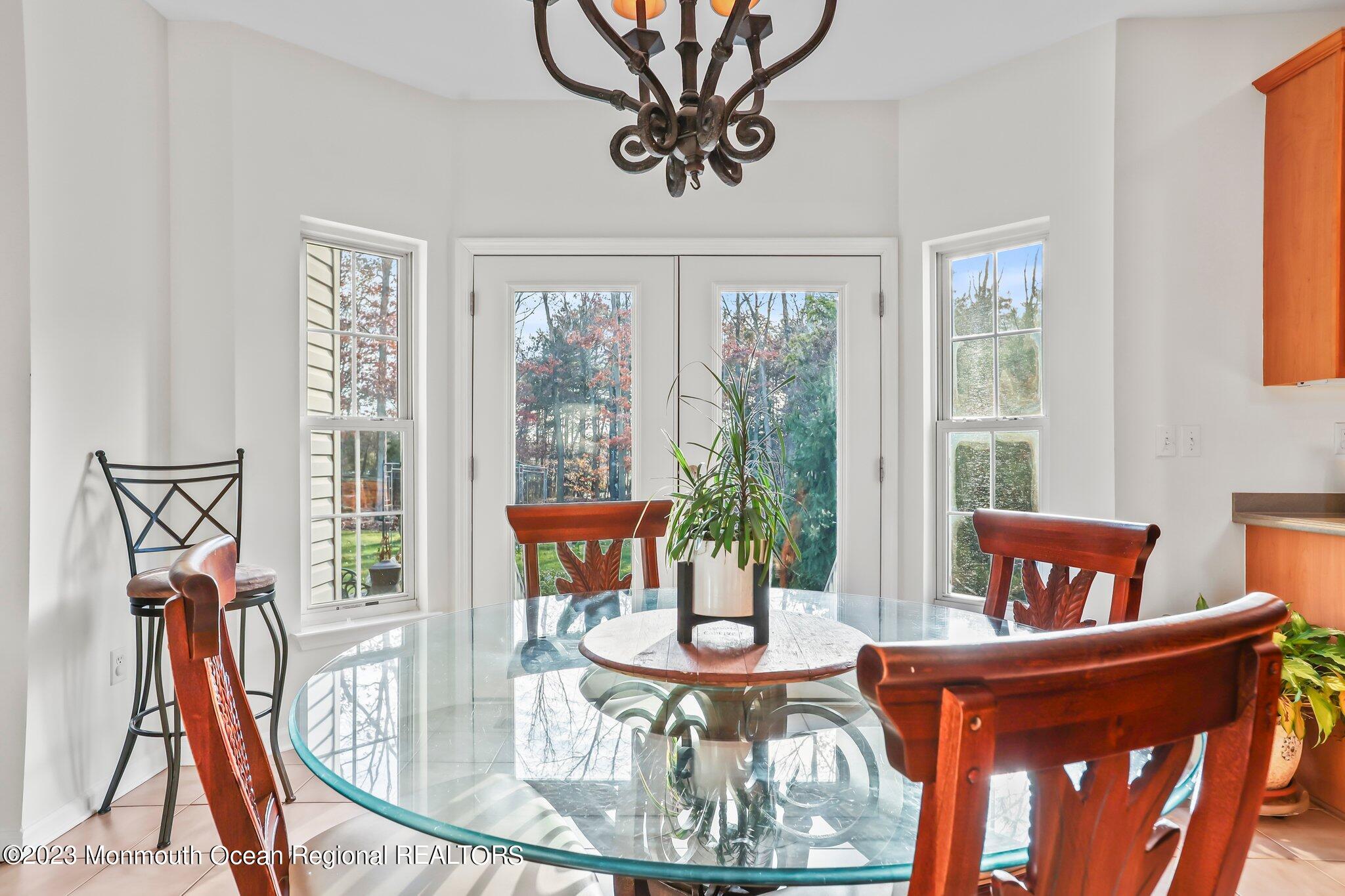 20 Round Hill Road Jackson, NJ 08527 - Photo 16 of 50 a dining room with furniture a chandelier and wooden floor