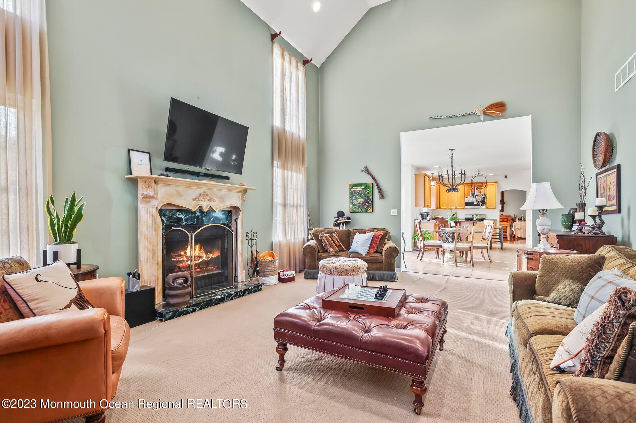 20 Round Hill Road Jackson, NJ 08527 - Photo 18 of 50 a living room with furniture flat screen tv and a fireplace