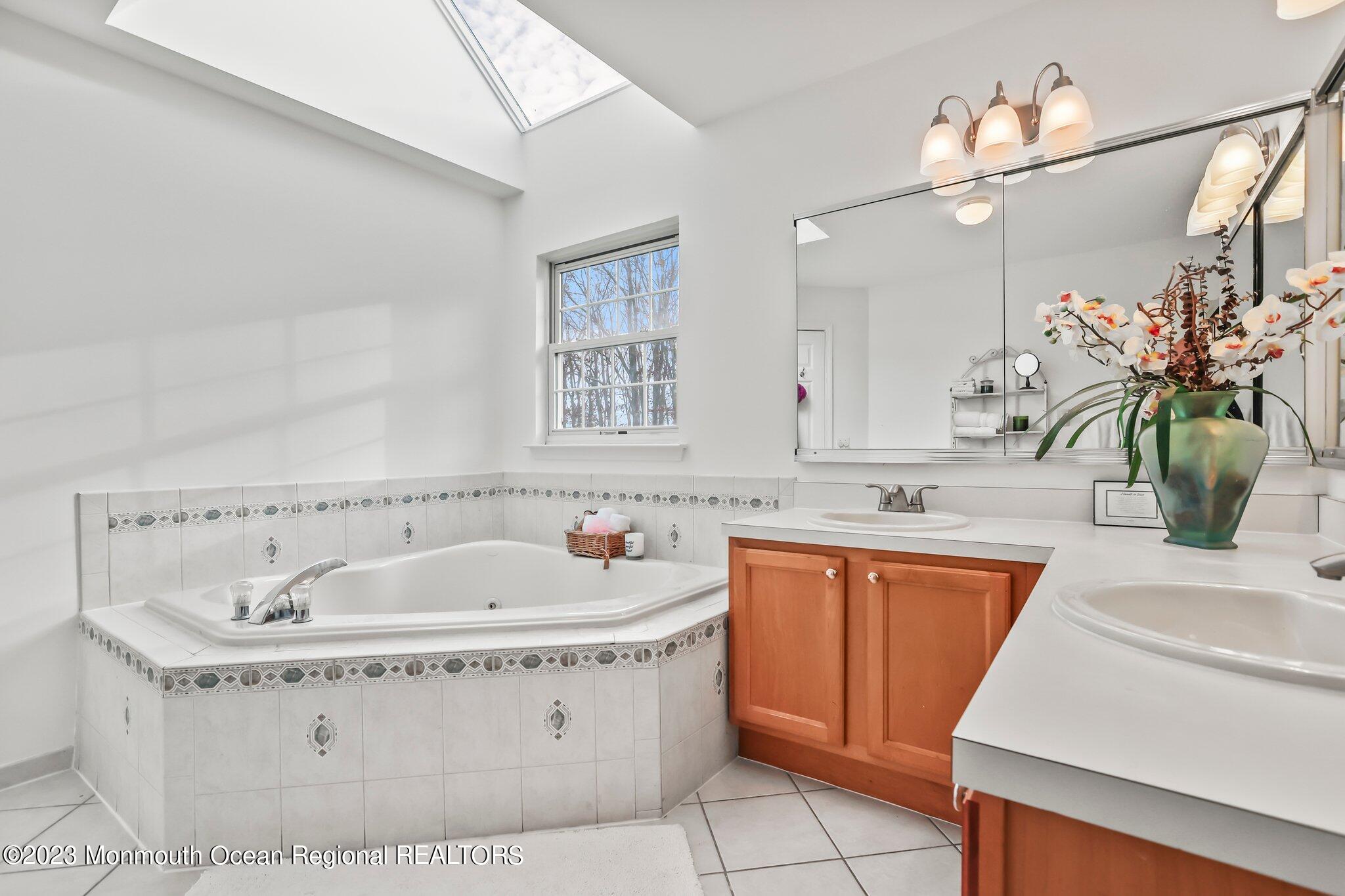 20 Round Hill Road Jackson, NJ 08527 - Photo 25 of 50 a bathroom with a tub sink and mirror
