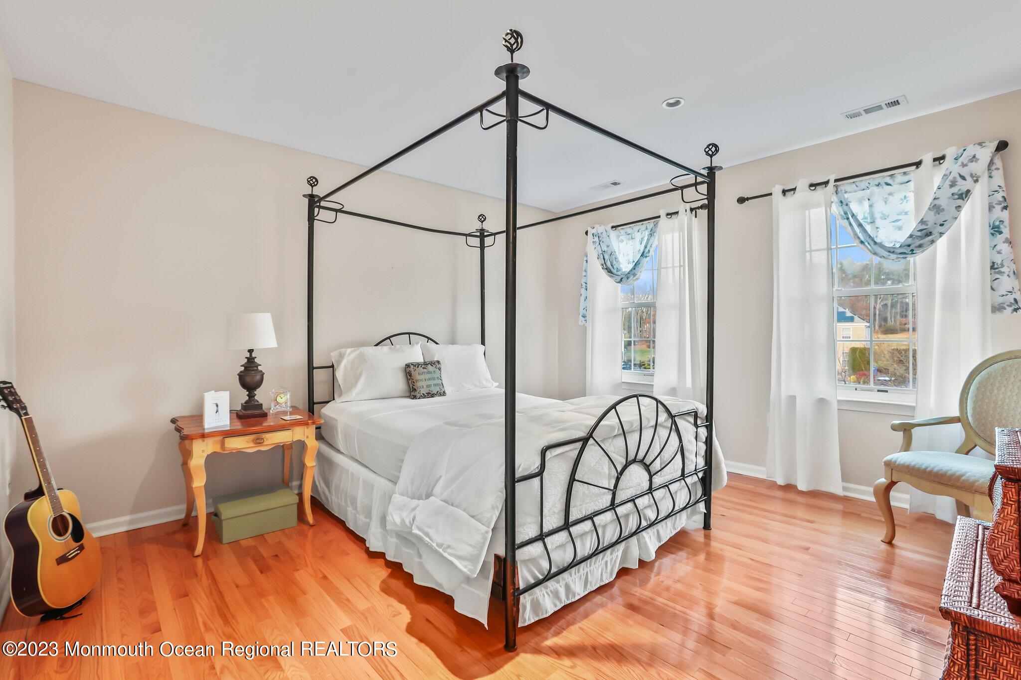 20 Round Hill Road Jackson, NJ 08527 - Photo 27 of 50 a bedroom with a bed and a chandelier