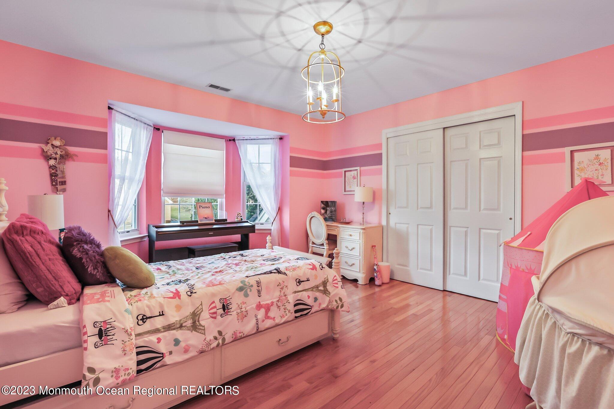 20 Round Hill Road Jackson, NJ 08527 - Photo 29 of 50 a bedroom with a bed chandelier and a window