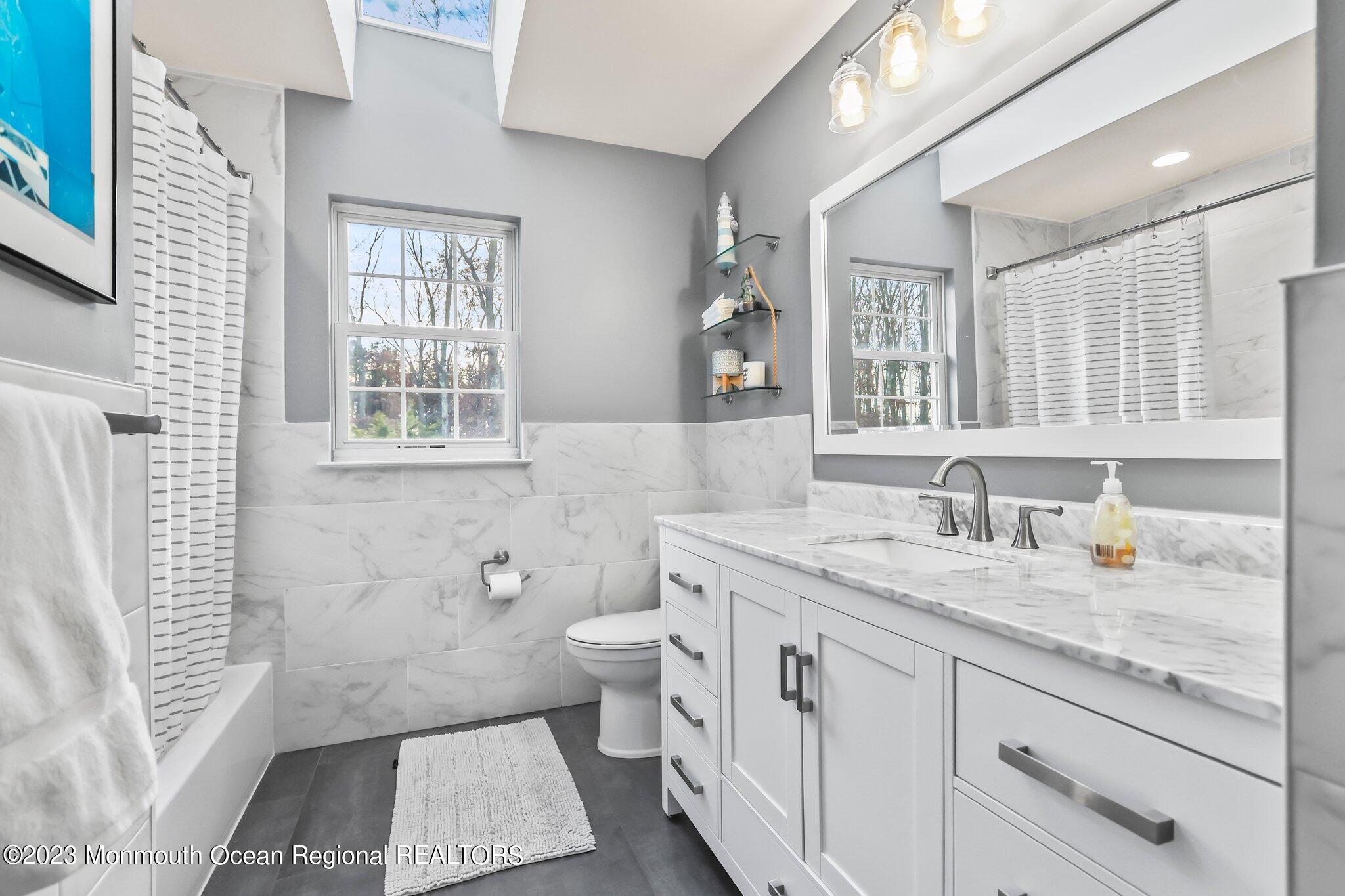 20 Round Hill Road Jackson, NJ 08527 - Photo 30 of 50 a bathroom with a granite countertop double vanity sink a mirror and a toilet