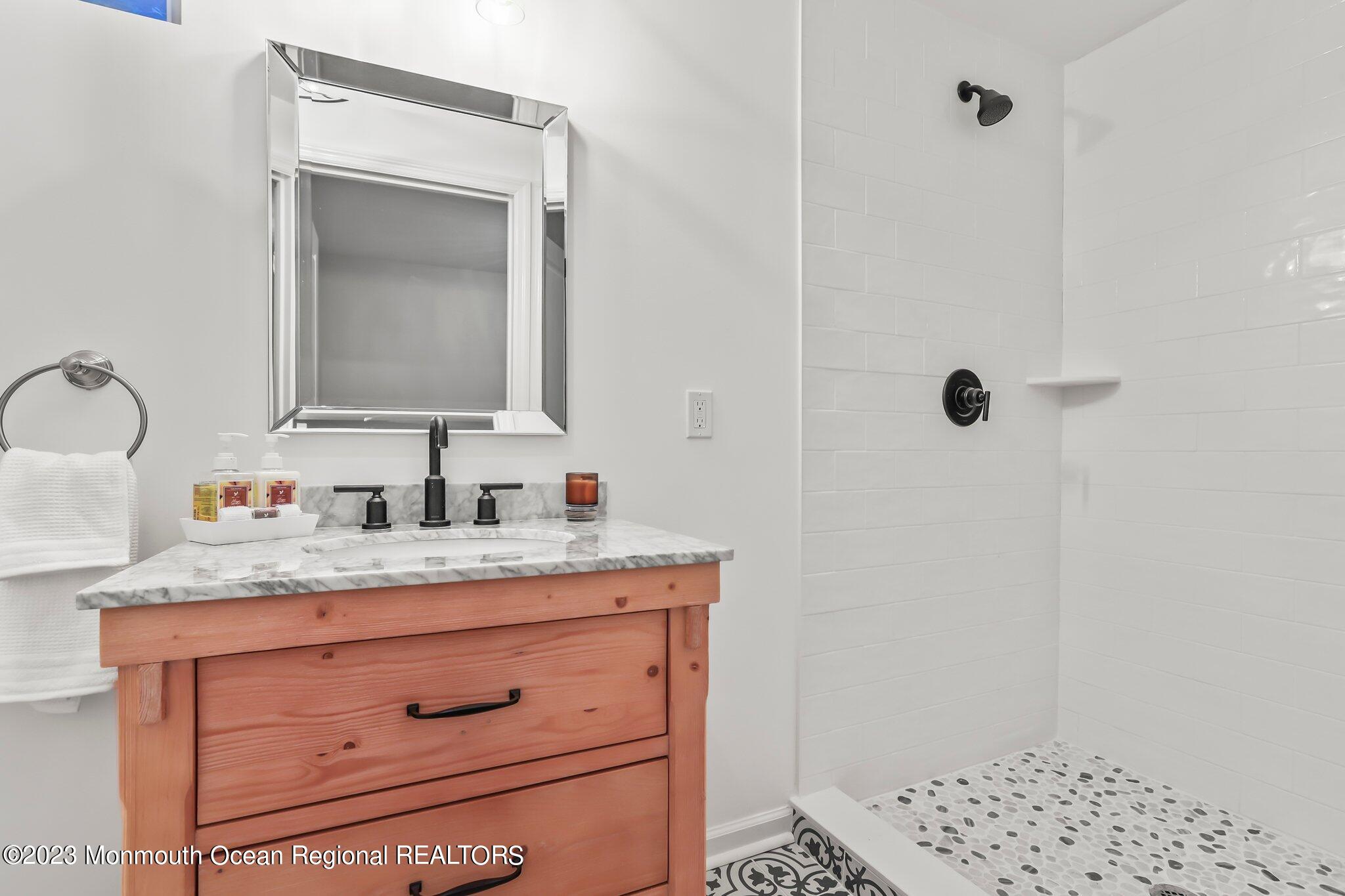 20 Round Hill Road Jackson, NJ 08527 - Photo 32 of 50 a bathroom with a granite countertop sink and a mirror