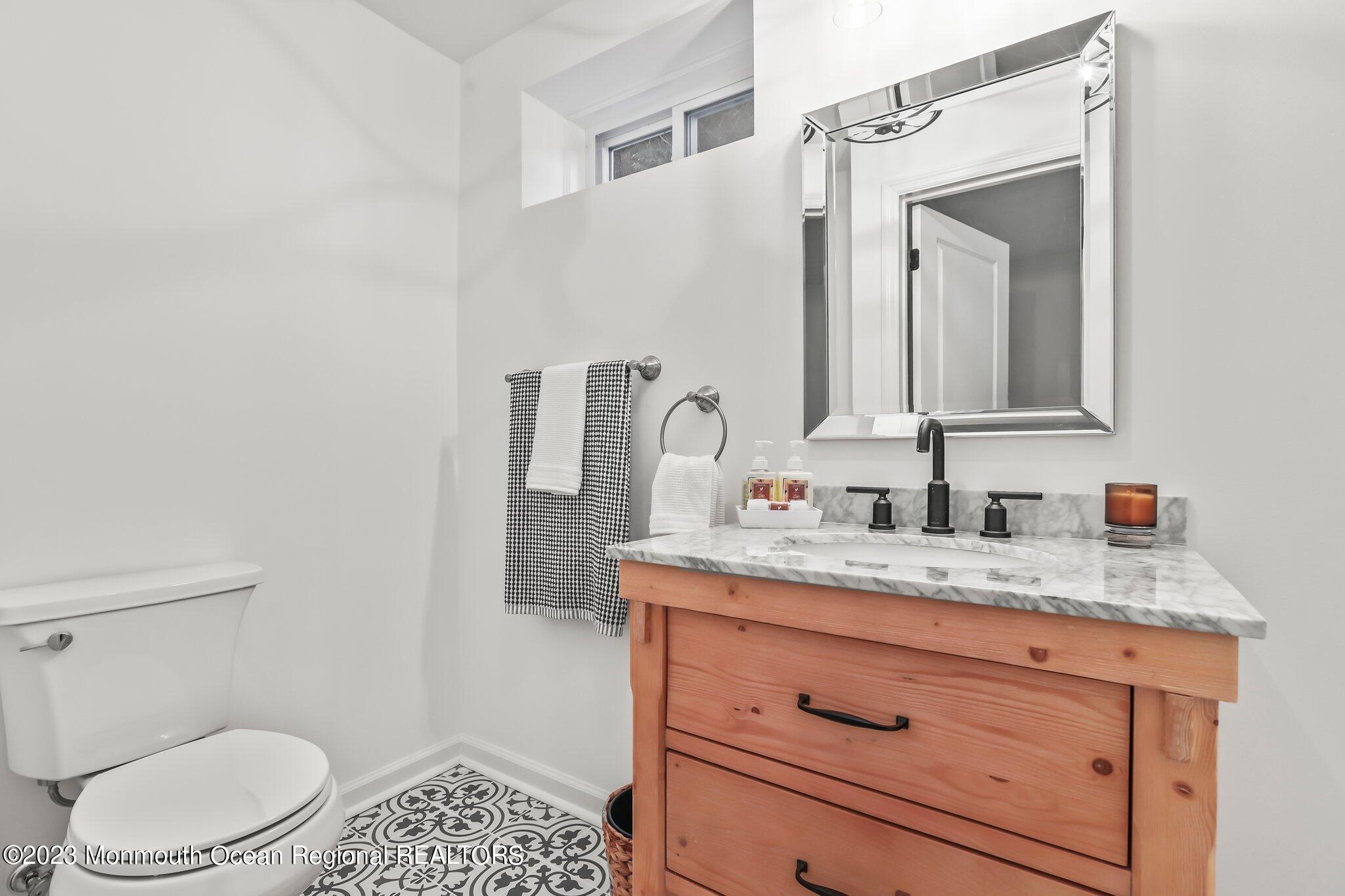 20 Round Hill Road Jackson, NJ 08527 - Photo 33 of 50 a bathroom with a granite countertop sink vanity mirror and toilet