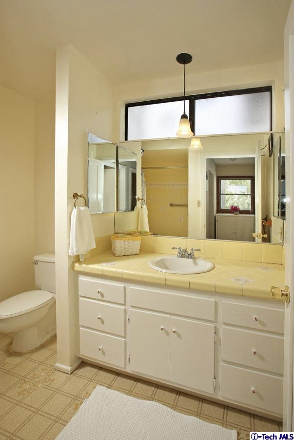 2118 Maiden Lane Altadena, CA 91001 - Photo 13 of 15 a bathroom with a granite countertop sink mirror vanity and toilet
